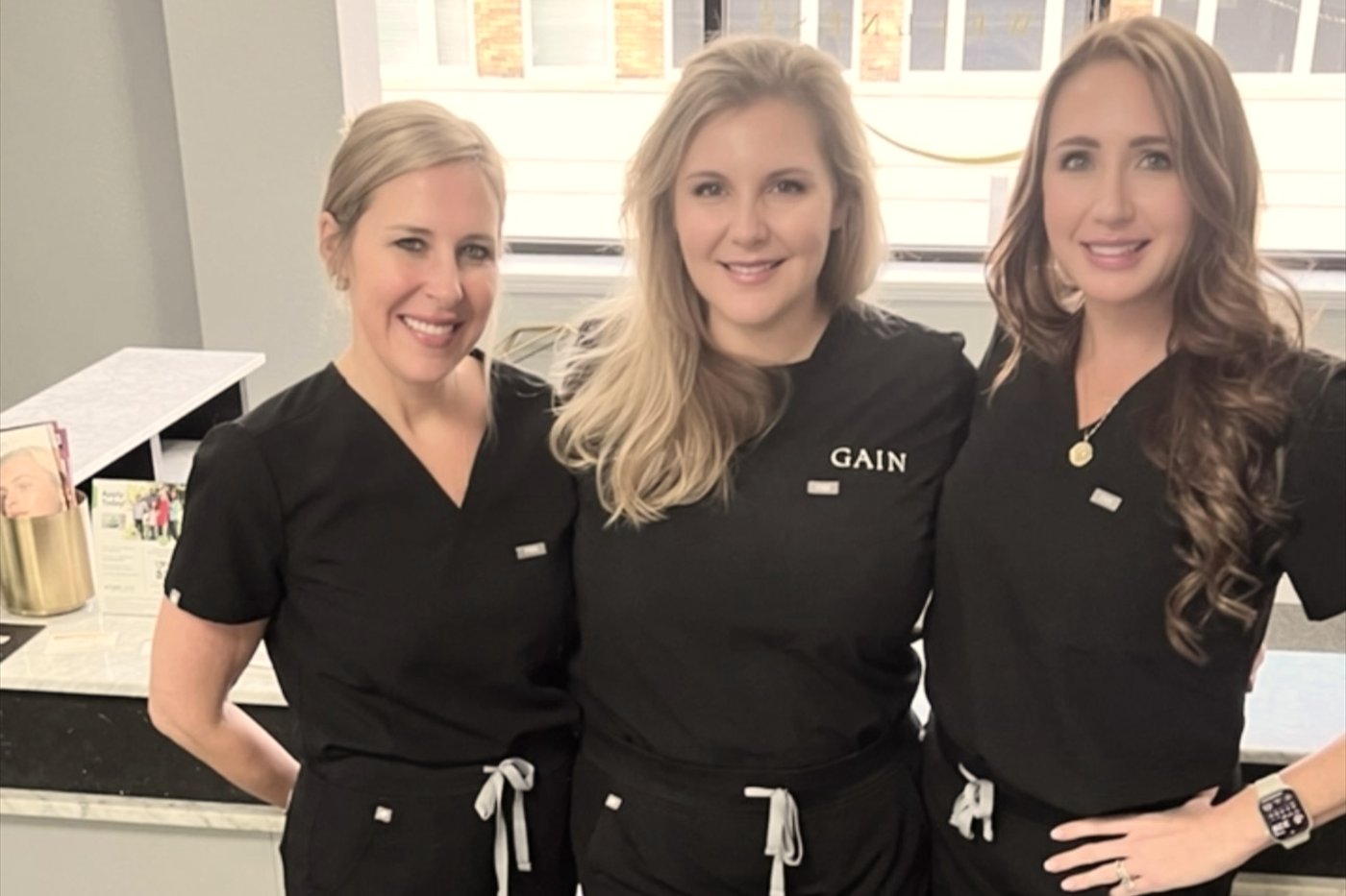 Lauren Meade in GAIN scrubs with two injectors at the end of a training day